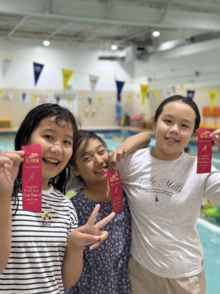 Three swimmers showing their level ribbons at WD Swim Richmond Hill