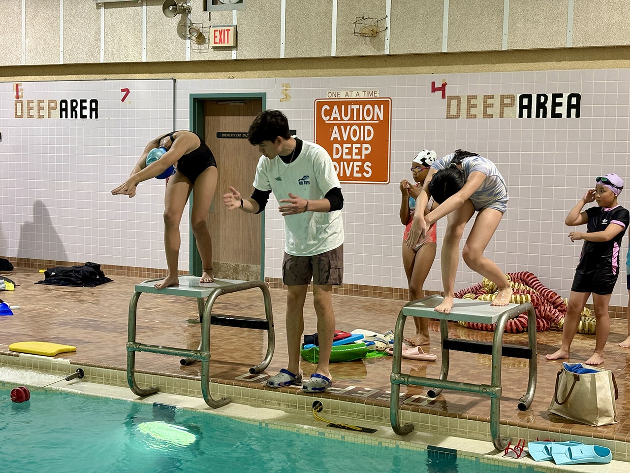 Swimmers practising racing starts at WD Swim North York