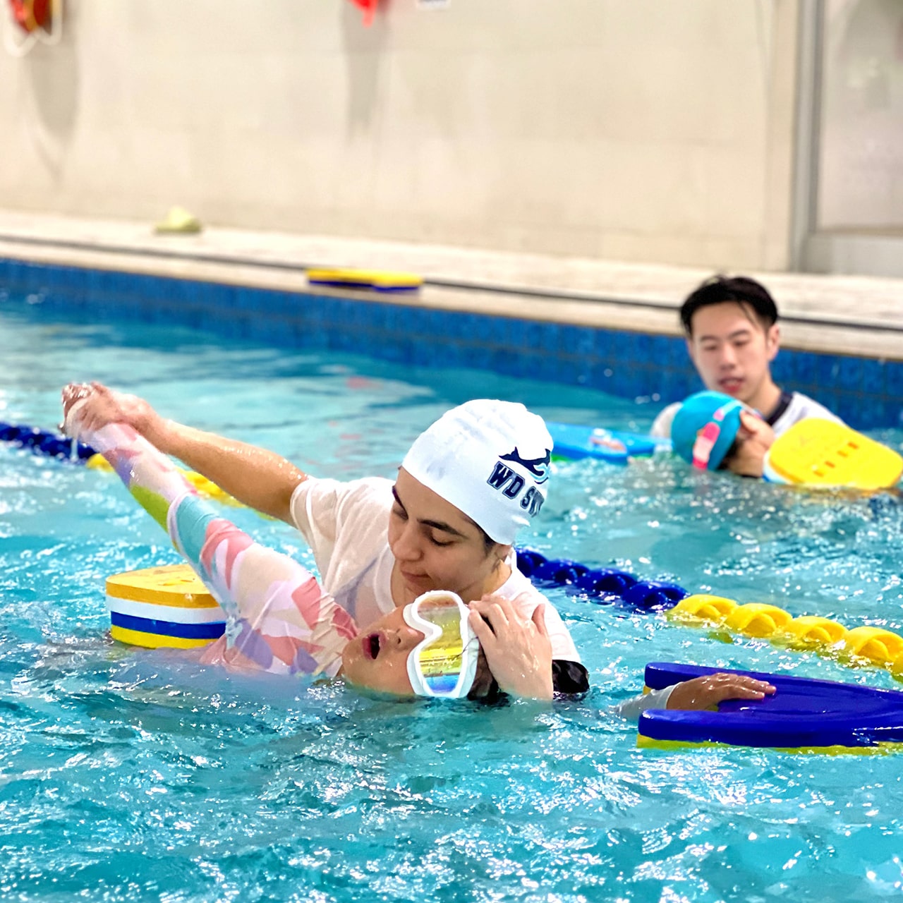 Coach giving a one-on-one private swimming lesson
