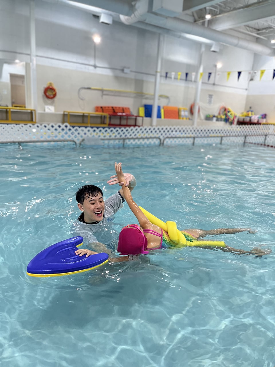 Instructor guiding a young swimmer during a private lesson